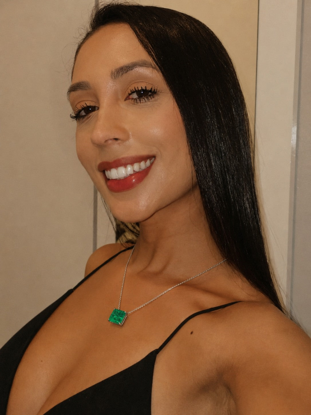 Green pendant necklace with a black dress